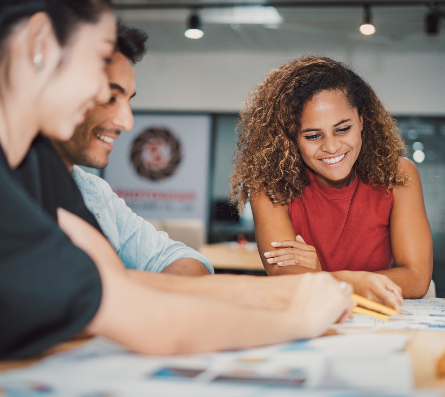 three people on a desk planning out something