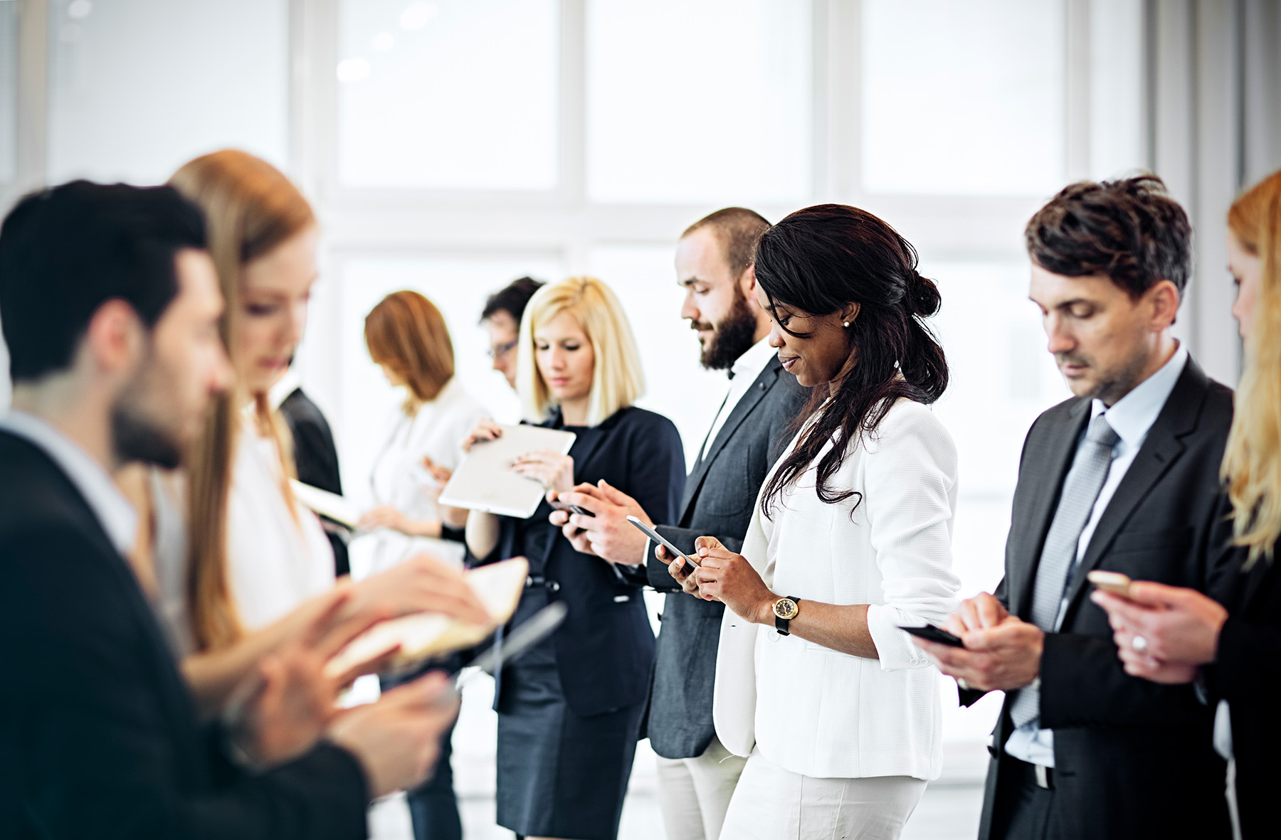 group of people looking at mobile devices